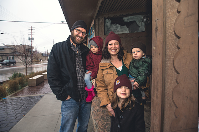 Anthony and Tiffany Andreoli standing with their three children.