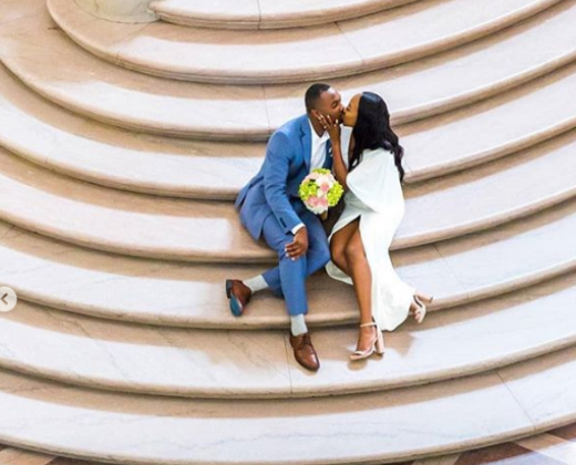 Bride and groom kissing on stairs