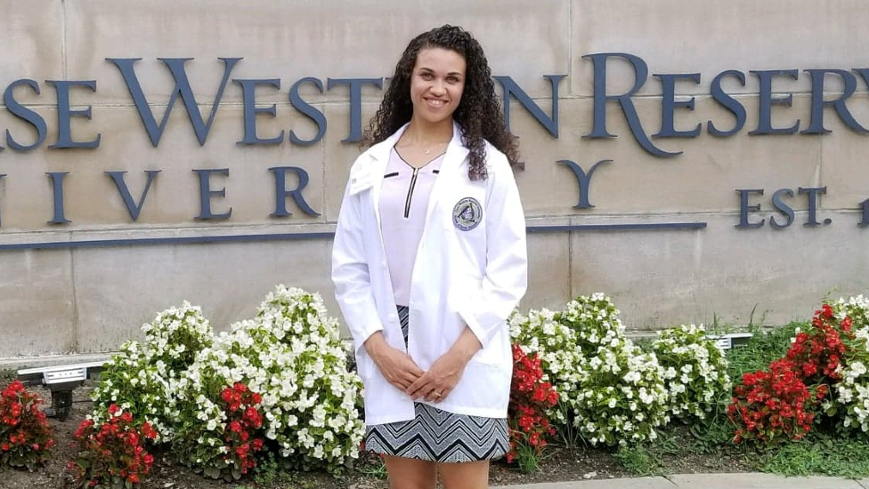 Doctor standing in front of Case Western sign