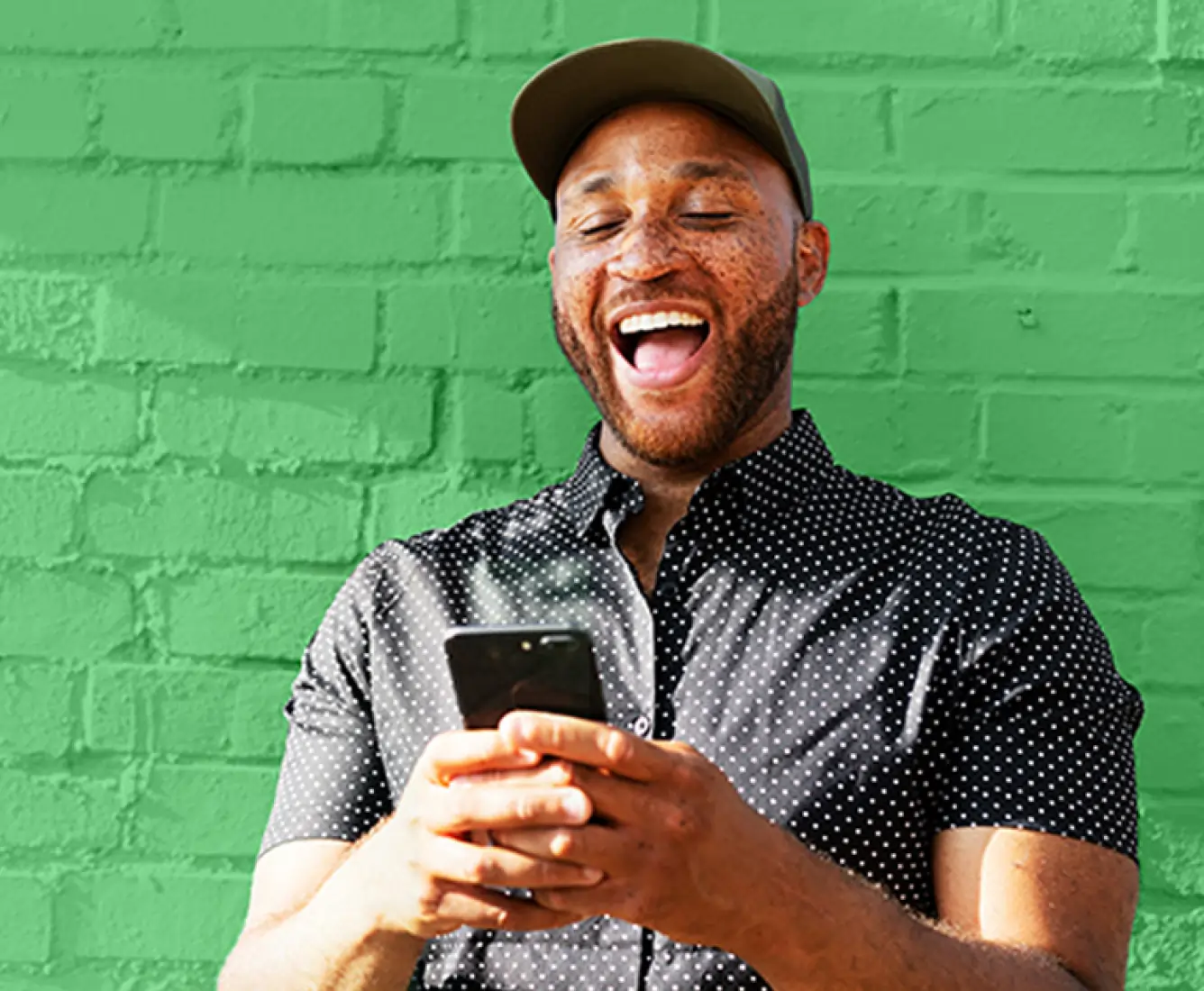 Happy man looking at his phone 
