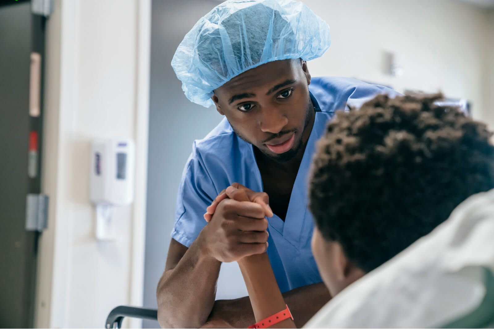 Doctor comforts child before surgery.