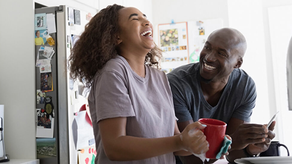 Couple laughing in kitchen