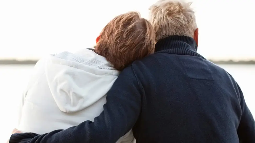 Couple hugging from back