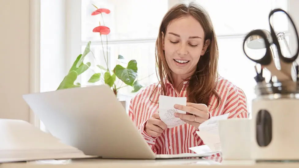 Woman looking at receipt