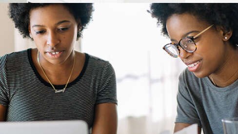 Two women looking at a computer