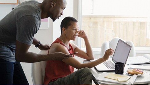 man and child looking at computer