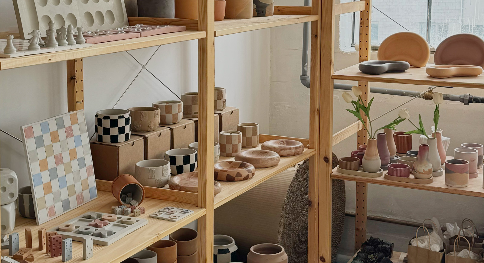 A shelf at Ivy Mane Studio filled with the owner's artistic concrete creations