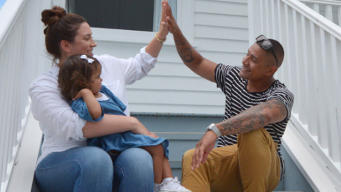 family high fiving on steps