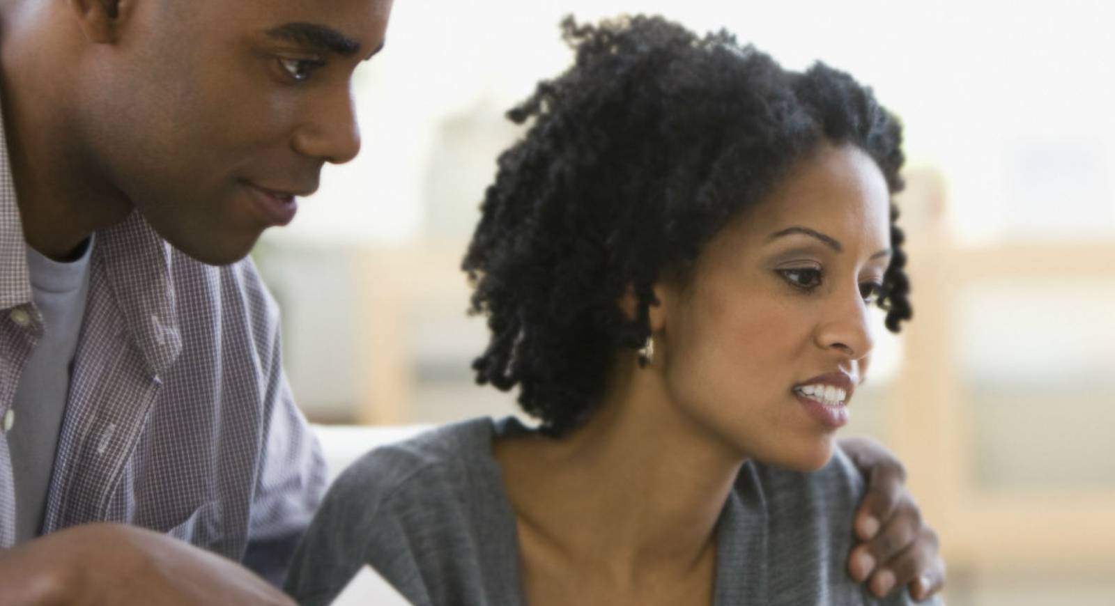 Couple sitting together looking at HELOC papers