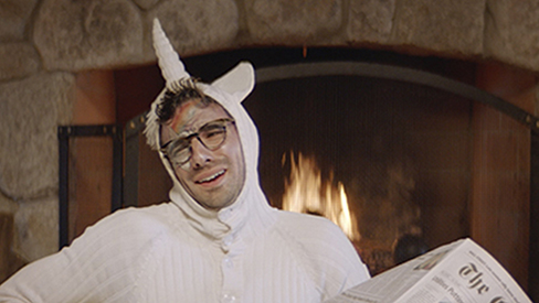 A man in a unicorn costume