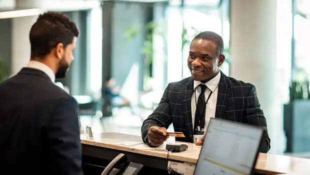 Men in a conference room around a computer