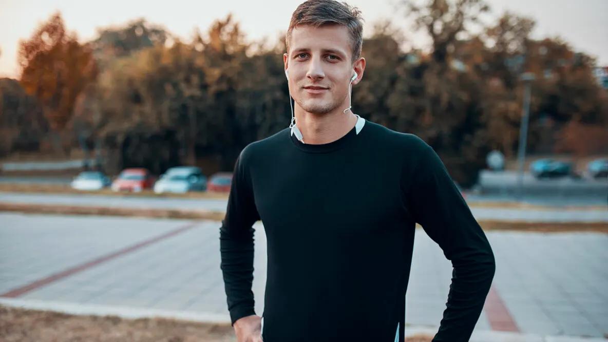 Portrait of sportive man outdoors in the evening