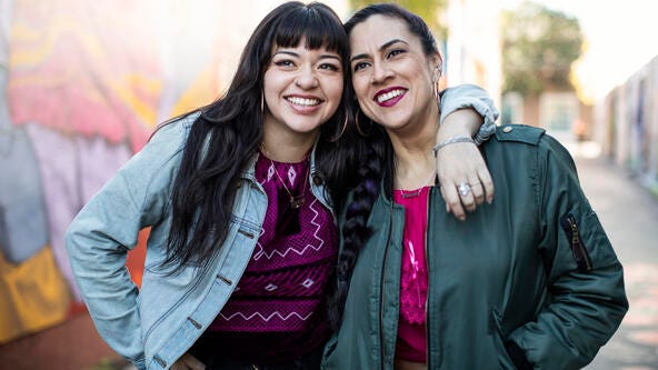 2 women walking in street