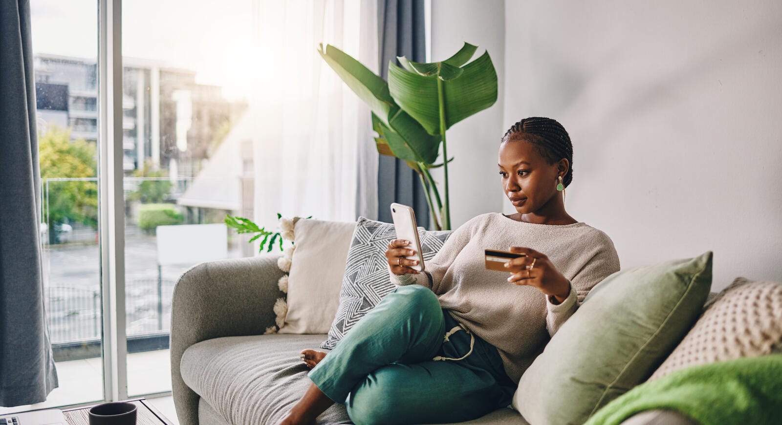 Women sitting on couch doing online shopping