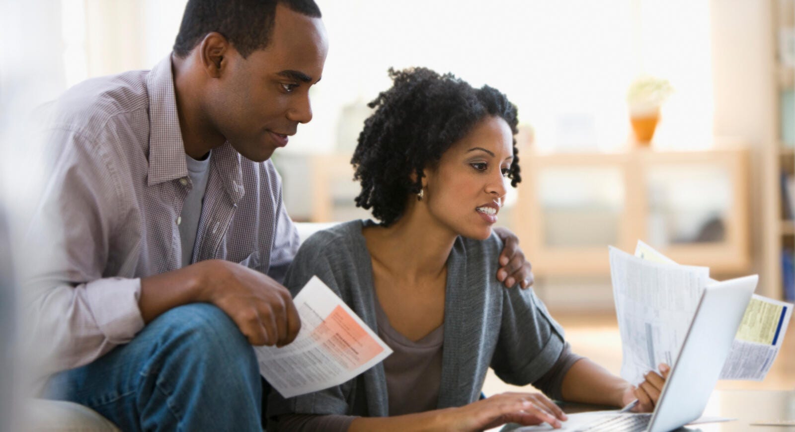 Couple sitting together looking at HELOC papers
