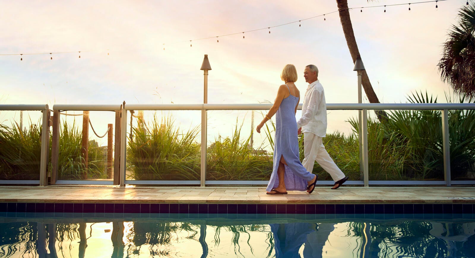 Couple walking near swimming pool