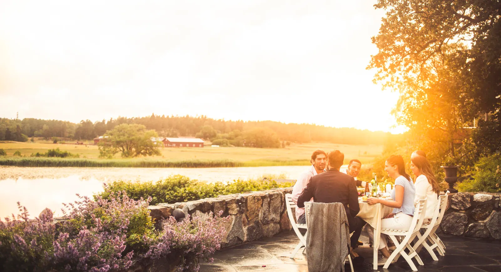 watherfront dining outdoors with a farm in the distance