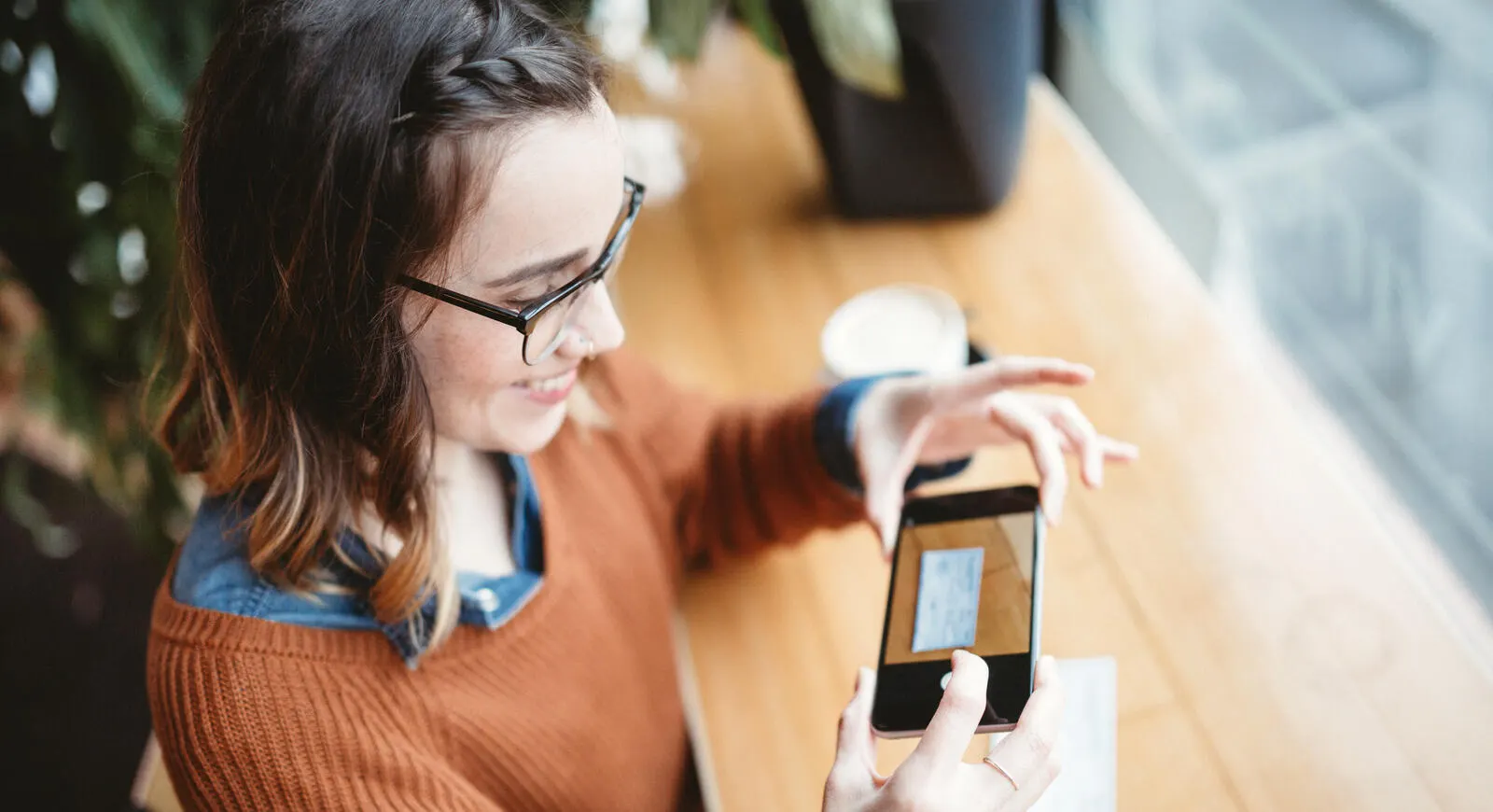 woman depositing check with cell phone