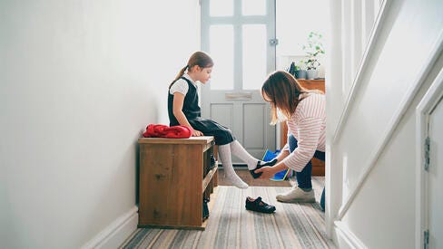 A family in a house entry hall getting ready for the day