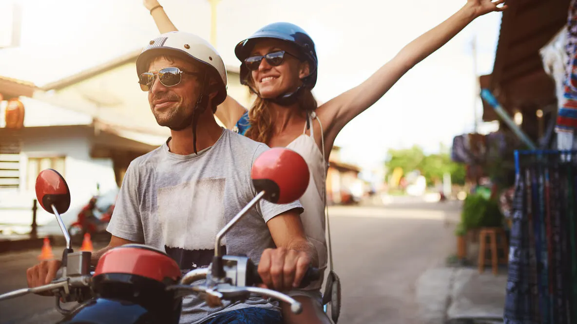 Young tourists enjoying a scooter ride around the city.