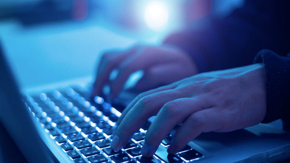 An up close image of hands typing.