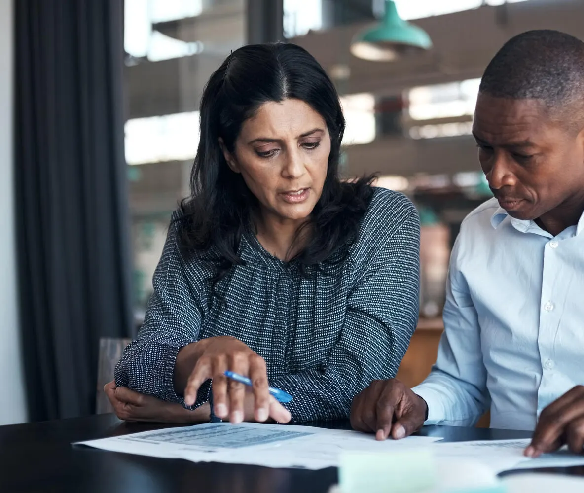 Shot of a business professionals going over paperwork in a modern office