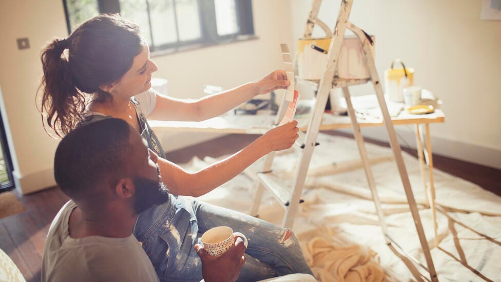 Woman measuring to hang item on wall