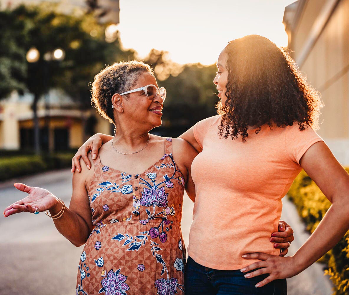 Two women smiling and talking