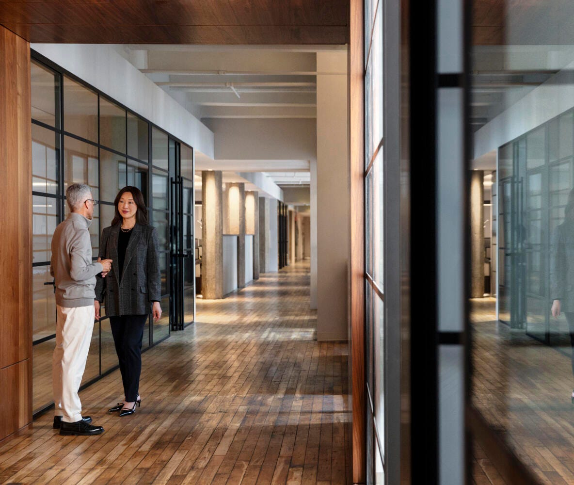 Two people chatting in the hallway