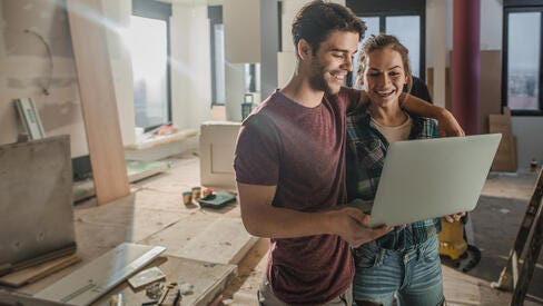 Woman and man working on computer