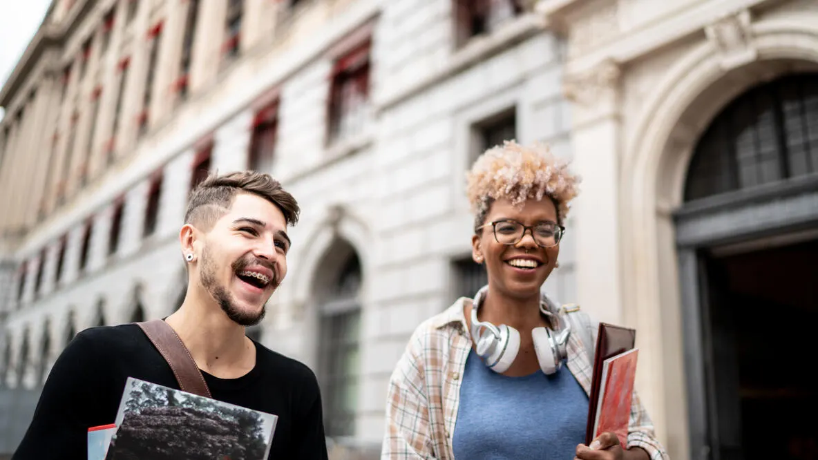 A man and woman walking through a city