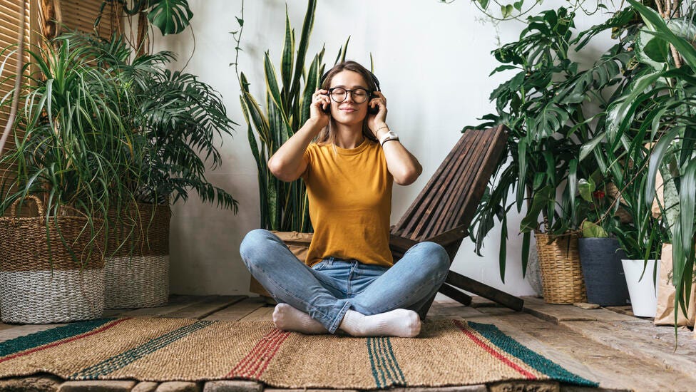 woman listening to music through headphones