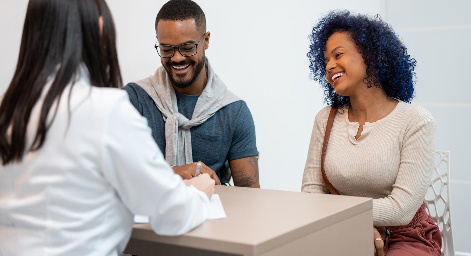 Young couple talking to a banker.