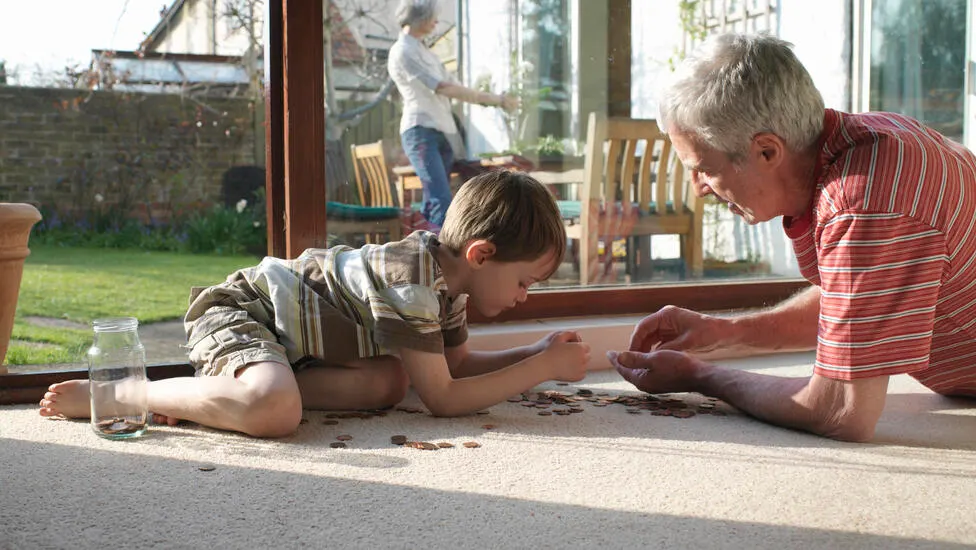 Grandfather and grandson coutning coins