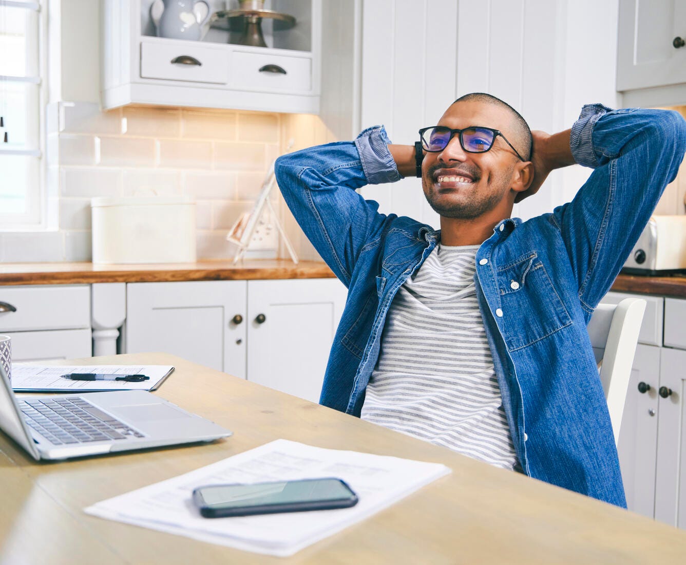 Man smiling leaning back in chair