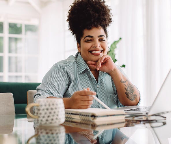 Woman sitting at desk working on computer