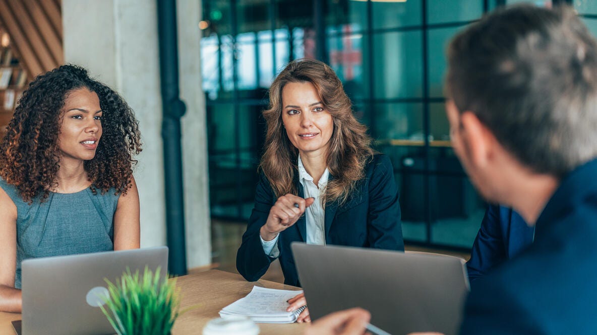 Several people having a business meeting in a conference room.