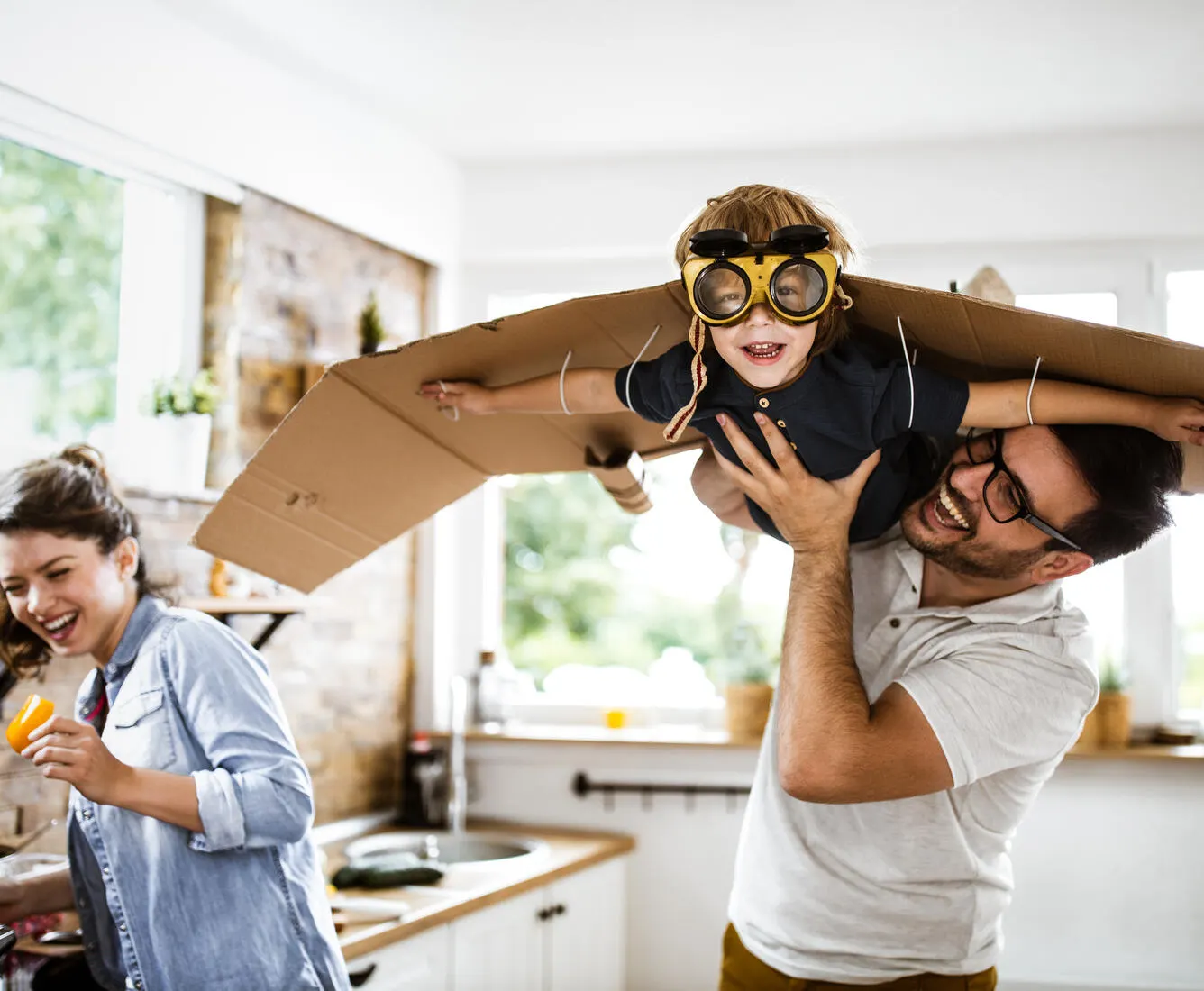 Dad hoisting son in air