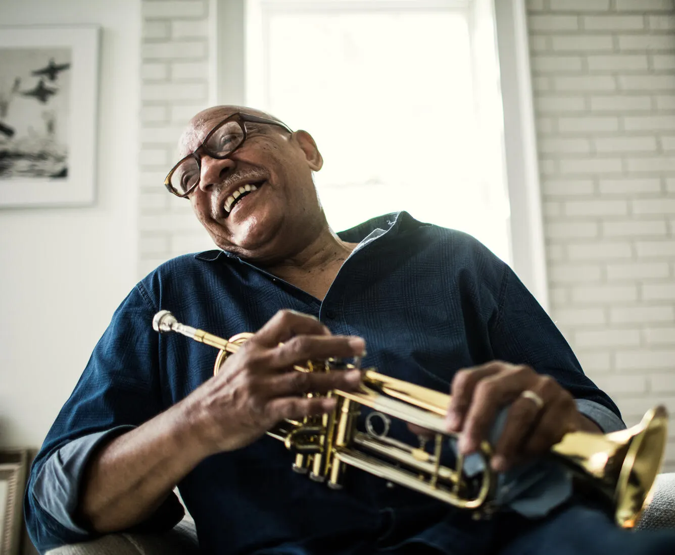Man sitting in chair with trumpet