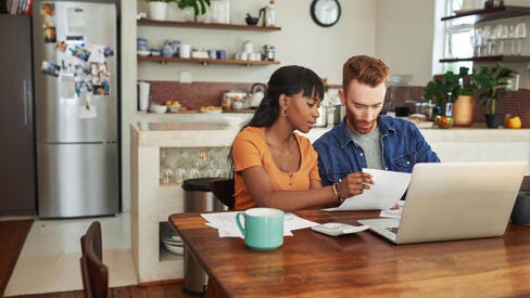 two people sitting looking at papers